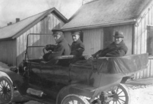 p75-3 "The P M" (apparently the Prime Minister of Canada) in the back seat of a touring car escorted by two soldiers.