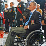 Captain Trevor Greene in wheelchair. This Seaforth officer was struck on the head by an axe in Afghanistan. Standing behind him wearing the turban is The Honourable Harjit Singh Sajjab, OMM, MSM, CD, Minister of National Defence.