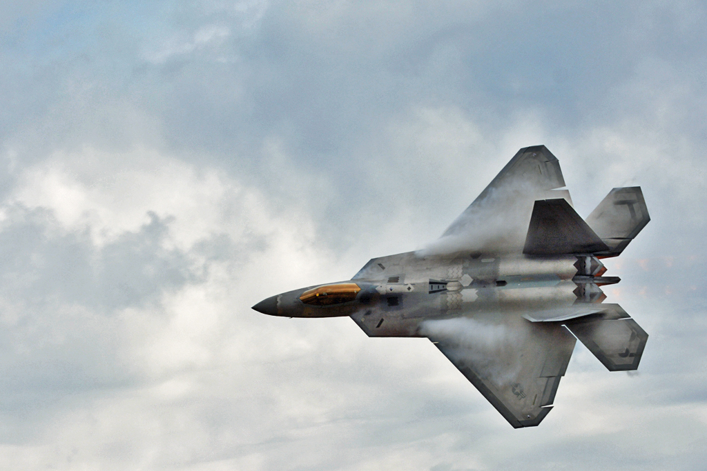 U.S.A.F. F-22 Raptor. Condensation on wings due to high speed in moist air. 