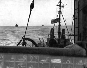 Looking aft on board a ship. Two convoy ships in the distance. "Our Convoy 24-3-42" 23 March 1942 on board HMCS Malpeque. (AHS p53 06 )