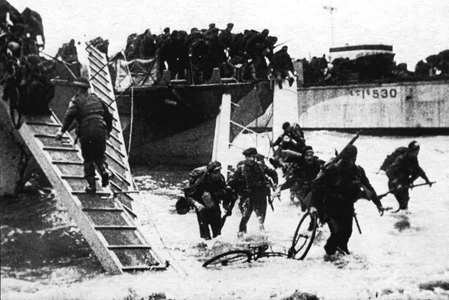 BSA Airborne Bicycle in the surf being dragged ashore on D-Day, June 6, 1944. The thoughts of this soldier or Marine are certainly not fit for young ears!