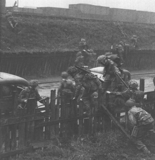 British Airborne troops training in England 1942-1944. Here they are crossing over a fence. 