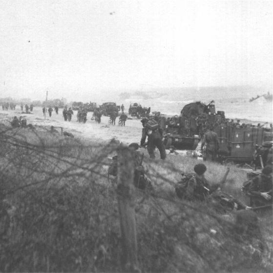 ritish Commando troops with some BSA Airborne Bicycles on shore awaiting the word to move inland. 