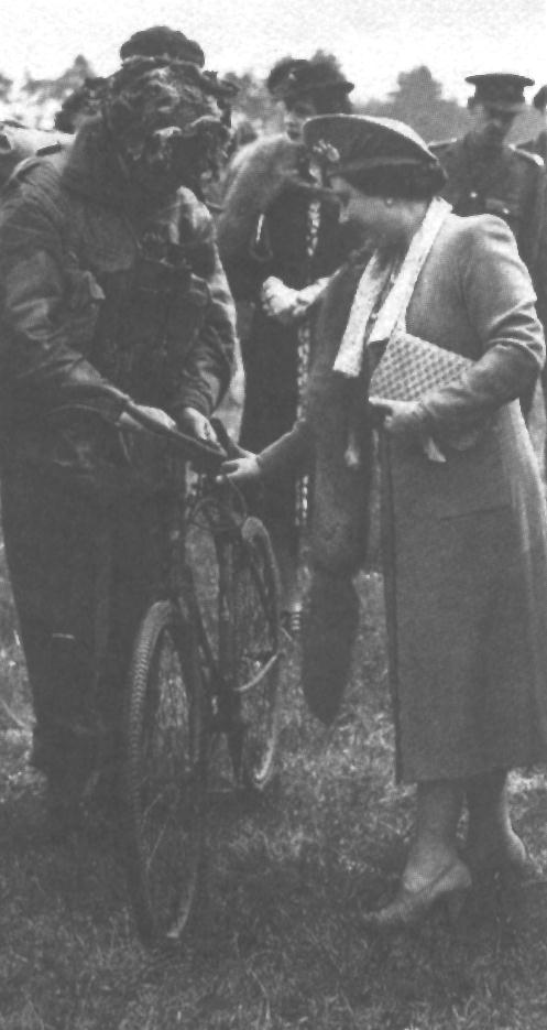 The Queen examining a BSA Airborne Bicycle, probably in May 1944.