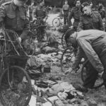 Royal Marine Commandos in Southern England immediately before D-Day, June 1944. They have BSA Airborne Bicycles with the Everest Carrier fitted to the front. They are having a kit inspection, so the loaded rucksack, rope etc. is not loaded onto the bicycles.