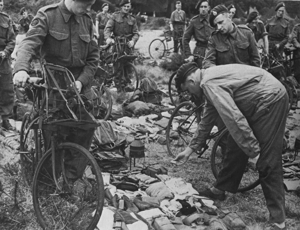 Royal Marine Commandos in Southern England immediately before D-Day, June 1944. They have BSA Airborne Bicycles with the Everest Carrier fitted to the front. They are having a kit inspection, so the loaded rucksack, rope etc. is not loaded onto the bicycles.