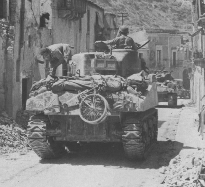 BSA Airborne Bicycle on the back of a Sherman tank of the Canadian 3 Rivers Regiment at Regalbuto, Sicily in 1943. It is obviously being carried for running errands etc. once that tank is in a hide.