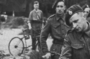 Royal Marine Commandos in Southern England immediately before D-Day, June 1944. They have BSA Airborne Bicycles with the Everest Carrier fitted to the front. They are having a kit inspection, so the loaded rucksack, rope etc. is not loaded onto the bicycles. A bicycle tool pouch, likely off of a rigid Mark IV bicycle, is visible on a bicycle in the background.(DETAIL)