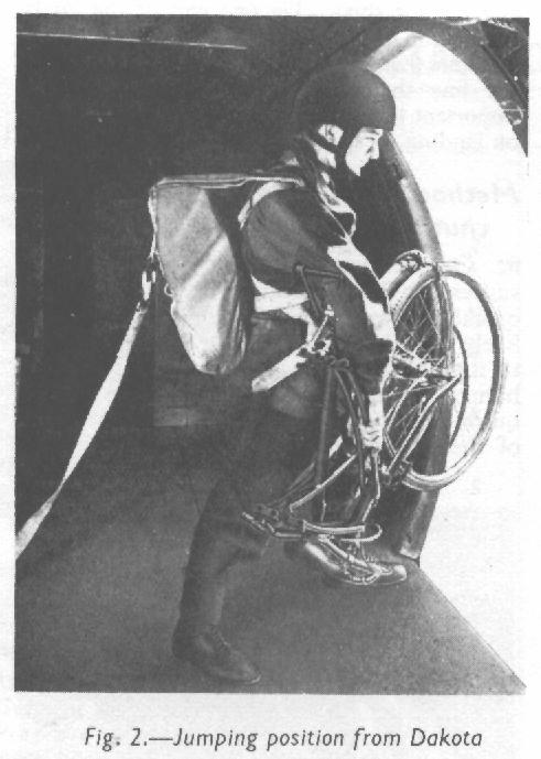 BSA Airborne Bicycle in the folded position for parachuting with a man. After his parachute opens, he will lower the bicycle about 20 feet below him. (Royal Air Force Manual)