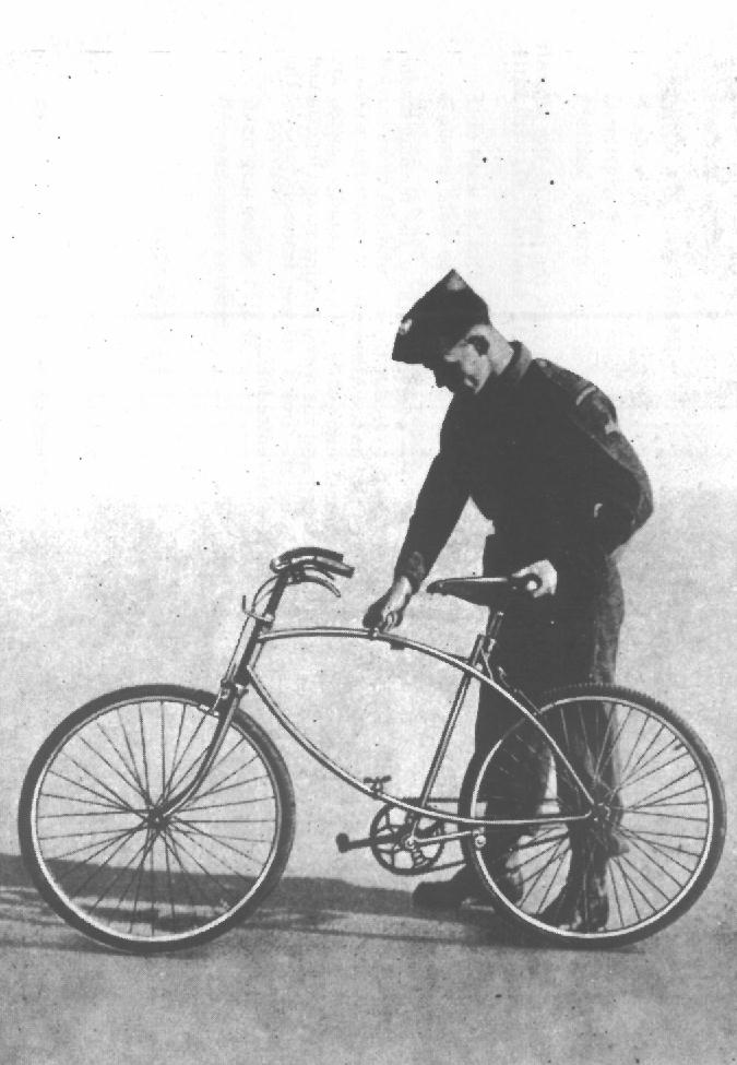 Solider tightening, or loosening, the upper butterfly nut that holds the bike open for riding. (from RAF Airborne Forces manual)