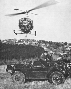 Canadian Army Ferret Scout Car 54-82542 shown in Germany with Canadian Army helicopter hovering overhead. Cdn Army Journal 1963 Vol XVII No2 p69