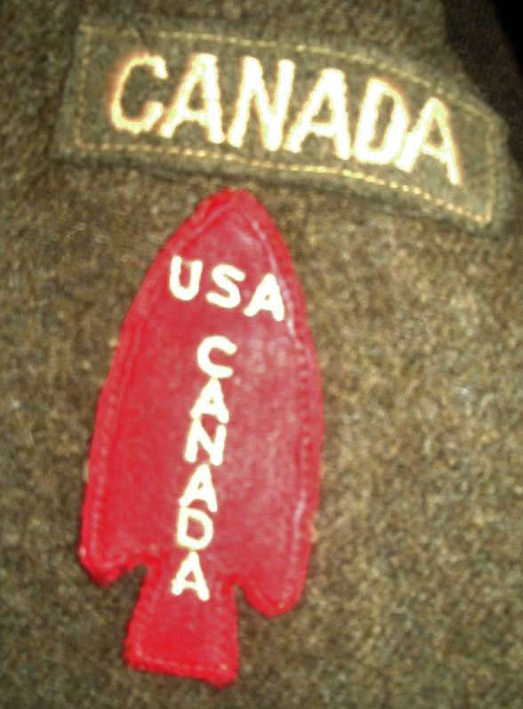 USA - CANADA First Special Service Force red spearhead patch on battledress under a CANADA title. Lieut Larry Story's battledress from after disbandment of FSSF when he and the other Canadians returned to the Canadian Army. 