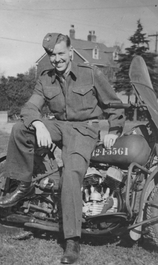 WWII Canadian Army officer leaning against his mopotorcycle. Lieutenant A. H. (Pete) STEVENS Lincoln and Welland Regiment. 1942 in Newfoundland with his new Harley-Davidson WLC motorcycle DND number 42-1-5561