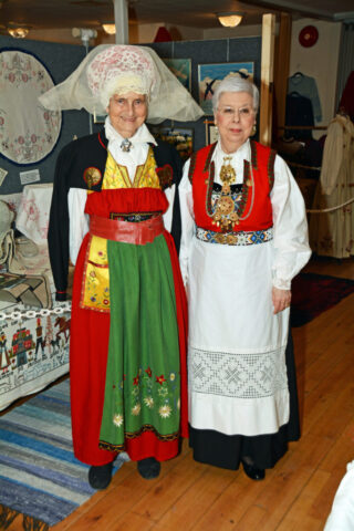 Jeanette Stevens on the right in her Norwegian bunad at a Scandinavian Centre event, in Burnaby, BC, 2016. The lady with the green apron is wearing a Swedish folk costume. Two ladies in Scandinavian folk cotumes.