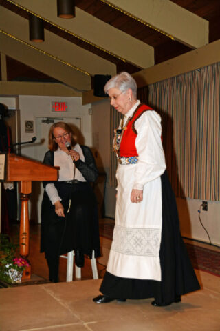 Jeanette Stevens on the right in her Norwegian bunad at a Scandinavian Centre event, in Burnaby, BC, 2016. The lady with the green apron is wearing a Swedish folk costume. Jeanette Stevens in her bunad at a Scandinavian fashion show, 2016.