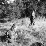 Two snipers. One advances while the other one covers him. This MAY be 1944-10-09 the Scout Platoon of the Queen's Own Cameron Highlanders of Canada at Fort de Brasschaat, Belgium