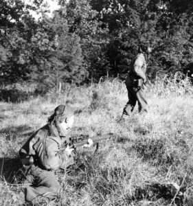 Two snipers. One advances while the other one covers him. This MAY be 1944-10-09 the Scout Platoon of the Queen's Own Cameron Highlanders of Canada at Fort de Brasschaat, Belgium