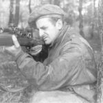 British WWII Sniper aiming his rifle.