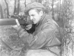 British WWII Sniper aiming his rifle.