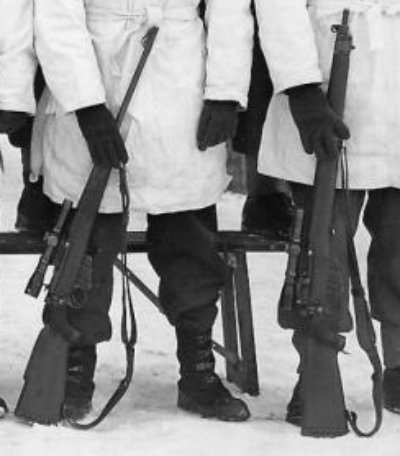 DETAIL showing two different model Lee-Enfield No. 4 sniper rifles - 1945-01-12 Third Snipers' Course at Camp Borden, Ontario, Canada. Note the variety of No. 4 (T) rifles. (Private collection)