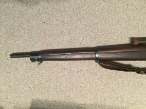 A late 1943 M1903A4 serial number 3422193. This rifle is original with the blued finish but the M73B1 scope has been refurbished by the military. - Left side of front section of rifle.