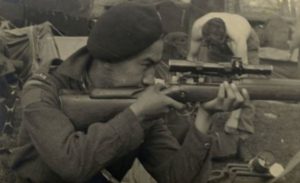 Canadian solider aiming with a Lee-Enfield sniper rifle.