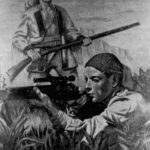Two men with rifles. Modern one in front, pioneer one behind.