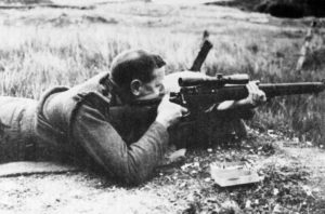 British soldier range testing the Canadian Long Branch rifle with experimental REL 5X scope.