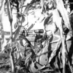 Canadian sniper in a cornfield. Location and date unknown. by Lt Ken Bell L&AC PA 211728