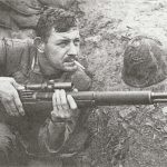 U.S. sniper Boitnott in Korea armed with an M1C sniper rifle fitted with an M81 or M82 Lyman scope.