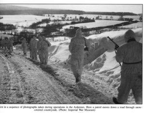 1945 JAN 14 - British 6th Airborne Division fighting patrol which includes a young sniper. Ardennes.