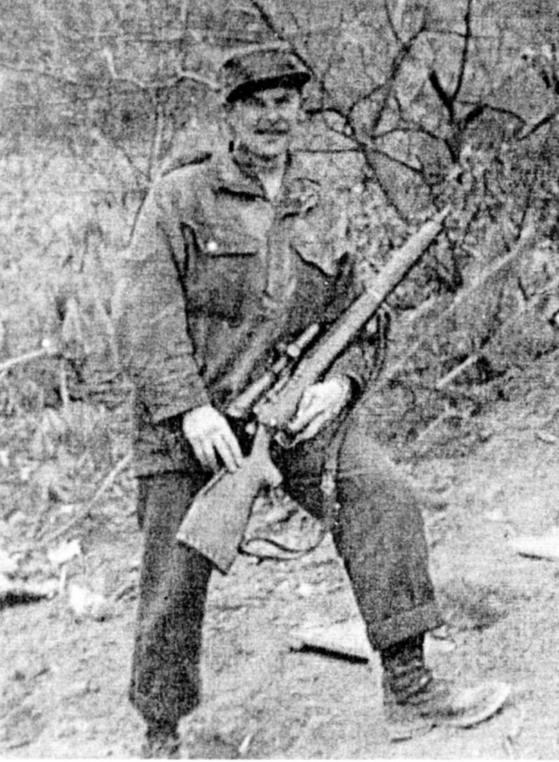 Canadian soldier holding his sniper rifle.