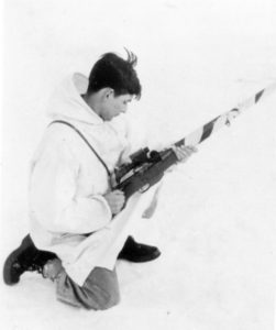 Canadian sniper with his camouflaged Ross MK. III with a Model 1913 Warner Swasey scope. He has the bolt pulled back ready to push it forward to load the rifle. This was during Winter training. (MilArt Photo Archives)