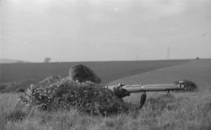 Canadian sniper in training England circa 1940-1941 behind rock. He is using a No. 1 MK. III* rifle without scope. (L&AC MIKAN 3607512)