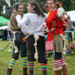 Three trolls showing their rope tails with knots.