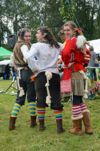 Three trolls showing their rope tails with knots.