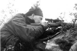 Canadian sniper aiming his No. 4 MK. I (T) sniper rifle. (L&AC PA136763)