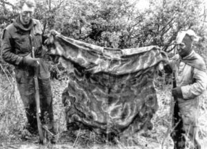 Snipers in training with camouflage garment held up . (L&AC PA21164)