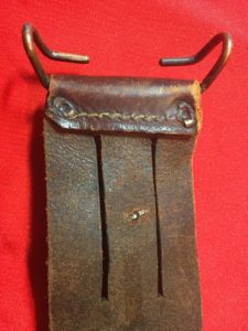 USMC Stiletto scabbard - back view of top showing the M1910 belt hook and belt slots. The two prongs of the rivet for the retaining strap are also visible. - Colin M Stevens' Collection
