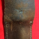 USMC Stiletto scabbard - back view of centre. The two holes of prongs of a rivet for a low retaining strap are also visible. - Colin M Stevens' Collection