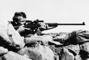 British sniper aiming his rifle.