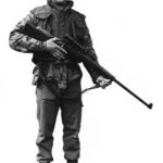 British Royal marine (?) standing holding a sniper rifle.