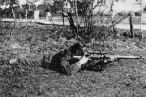 WWII British sniper in the regular prone shooting position. WBSTTR - Shore 1948 FP 119 BOTTOM