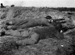 WWII British "sniper pair in training. "One shooting, one observing with telescope ... around cover. Notice the tremendous difference the sniper smock and camouflage veil man in a man's 'merging into the ground' compared with the battledressed and bareheaded observer. WBSTTR - Shore 1948 fp 263