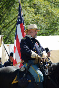 # 729 - Officer on horseback reviewing Union troops in camp before battle.