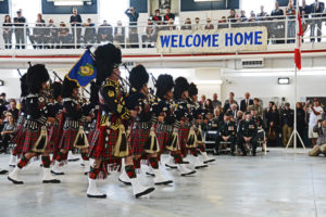 (360) Vancouver Police Pipe Band under the Welcome Home banner.