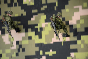 (404) Rappellers on the way down with C6 General Purpose Machine Guns sling. The C6 is a 7.62 variant of the FN MAG.