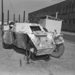 Ferret Scoyut car with front right wheel blown off by a land mine.