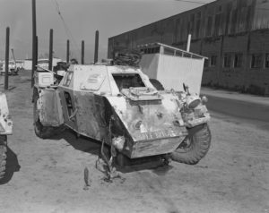 Ferret Scoyut car with front right wheel blown off by a land mine.