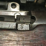 "S" mark on a No. 4 MK. I (T) indicating that the iron sights had been checked before the rifle was sent to Holland and Holland for sniper conversion.